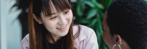 asian woman smiles talking to college