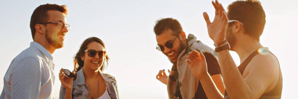 group of successful people stands talking laughing