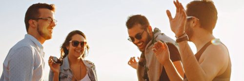 group of successful people stands talking laughing