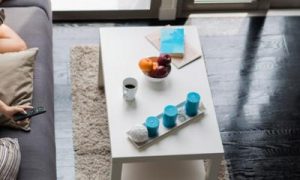 woman lies on couch in living room watching television