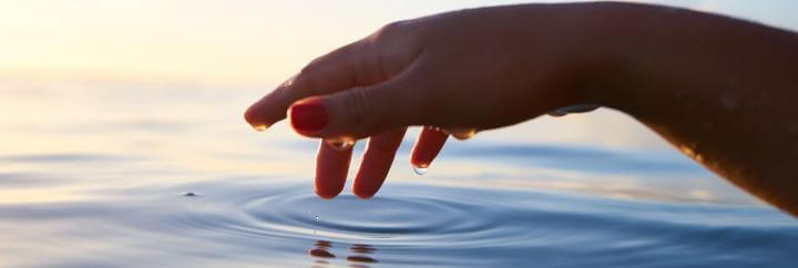 wet hand on water ripple