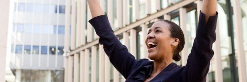 woman happy exciting celebrates tall business buildings
