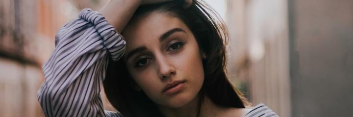 woman hand on hair sad face