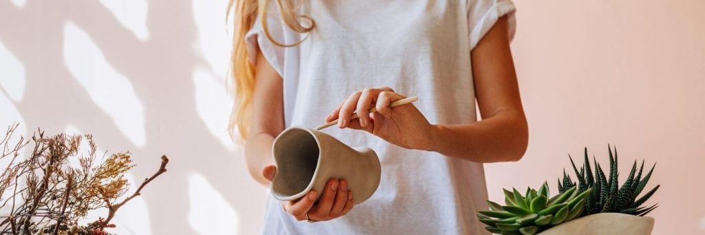 woman holding pot painting
