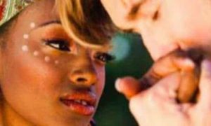 man kisses girlfriend hand while woman looking at him happily