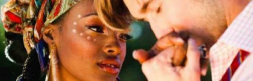 man kisses girlfriend hand while woman looking at him happily