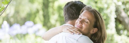 woman satisfied hugging boyfriend