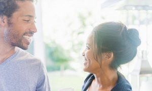 couple happily smiles looking at each other
