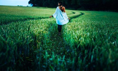 woman walking through grass