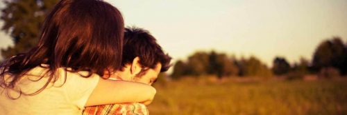 man carries partner walking on field
