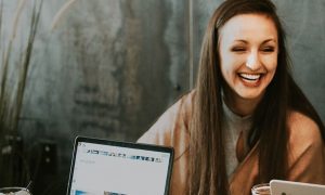 two women one man works in team talking laughing