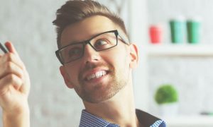 man undercut hairstyle carries pen pointing