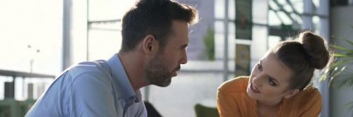 couple sits in living room communicating