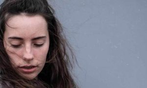 woman tired sad face looks downward