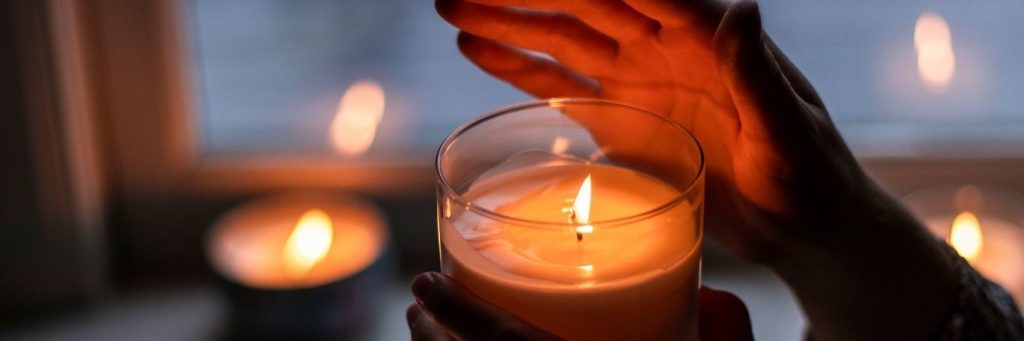 hand cover lighting in small candle cozy environment