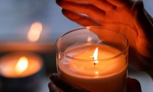 hand cover lighting in small candle cozy environment