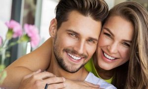 couple hugging happily smiling posing for photo