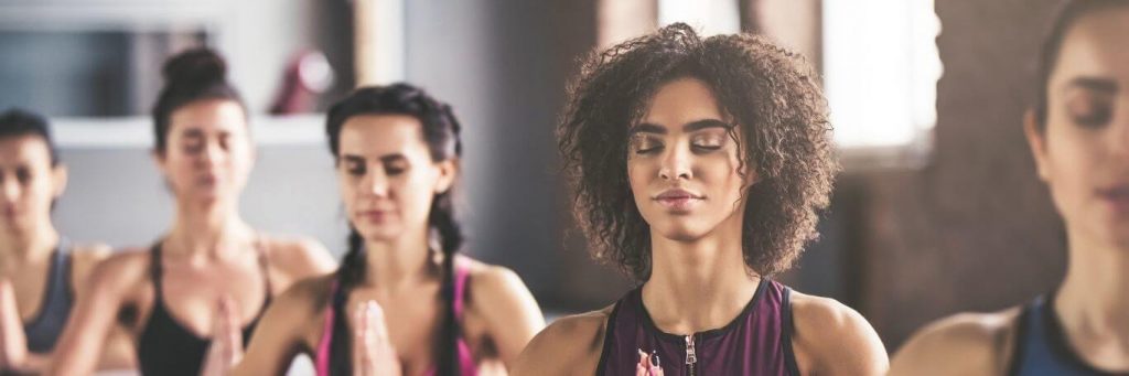 people exercise focus on meditation in fitness club