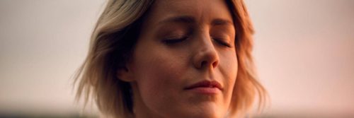 short hair woman eyes closed thinking