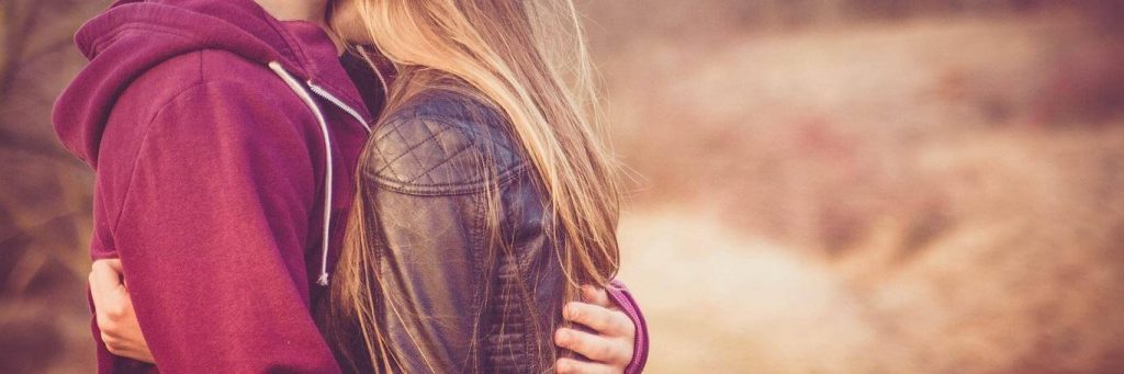 couple hugging kissing