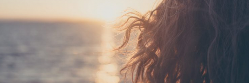 woman hair flying in sunset sky
